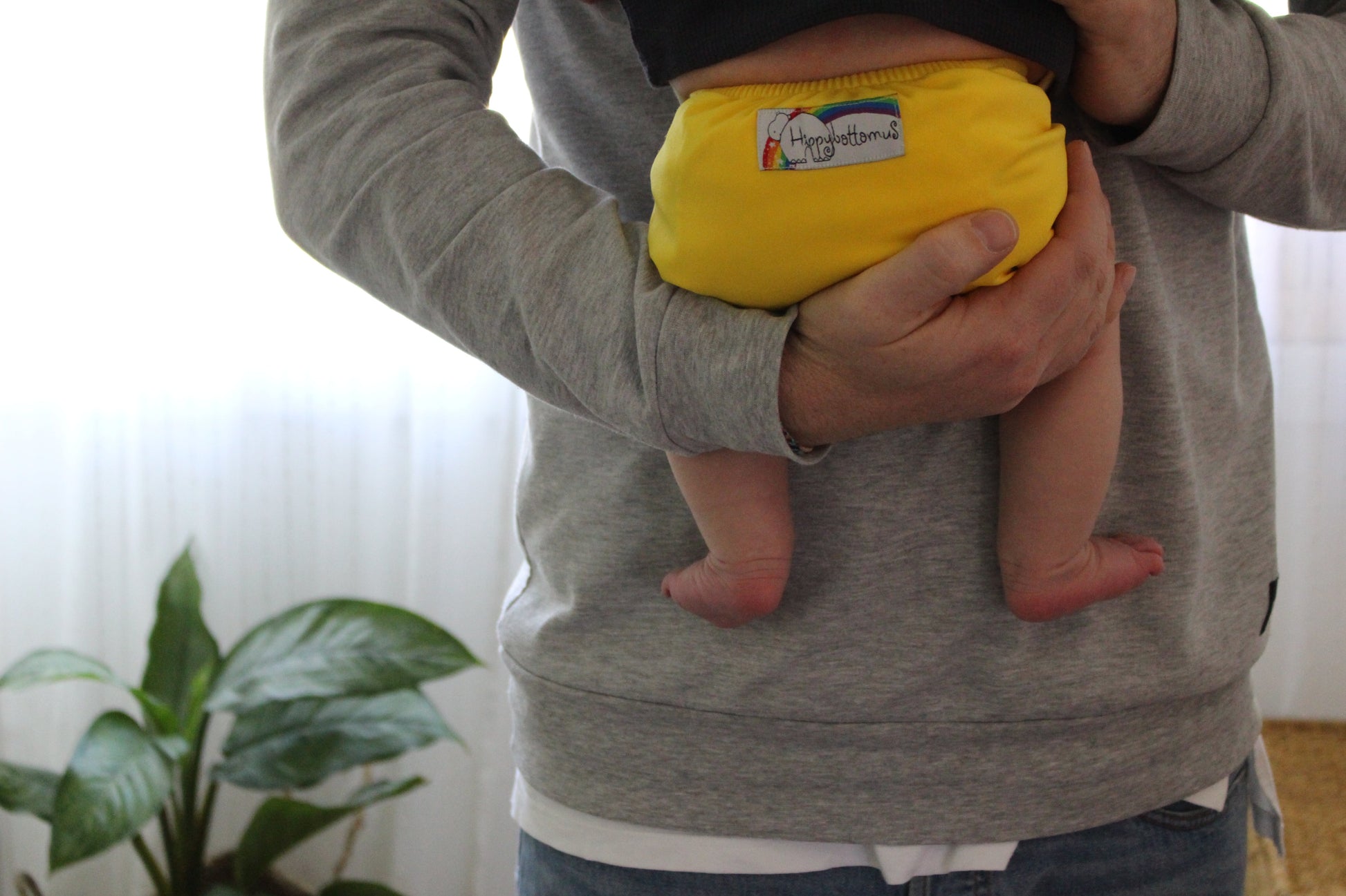 Dad holding baby in cloth nappy